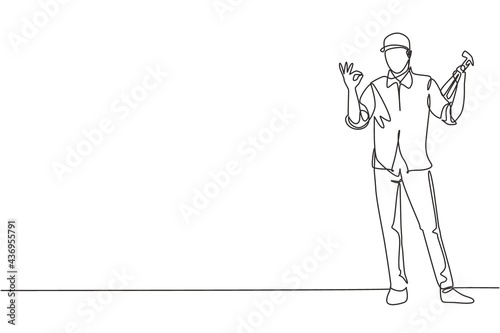 Single one line drawing of carpenter standing with gesture okay works for the wood industry and must be skilled at using carpentry tools. Modern continuous line draw design graphic vector illustration
