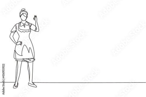 Single one line drawing maid in hotel stood with one hand on his waist and the other with gesture okay. Working with great hospitality. Modern continuous line draw design graphic vector illustration