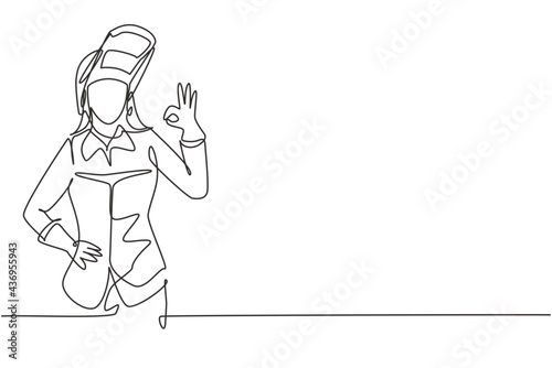 Continuous one line drawing female welder with gesture okay works in the construction of building forming steel frame that is melted by fire. Single line draw design vector graphic illustration