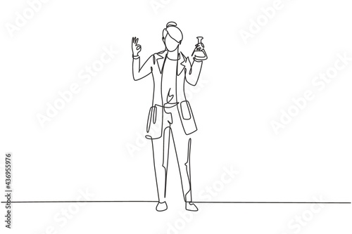 Single one line drawing female scientist stands with gesture okay and holding measuring tube filled with chemical liquid. Success work. Modern continuous line draw design graphic vector illustration