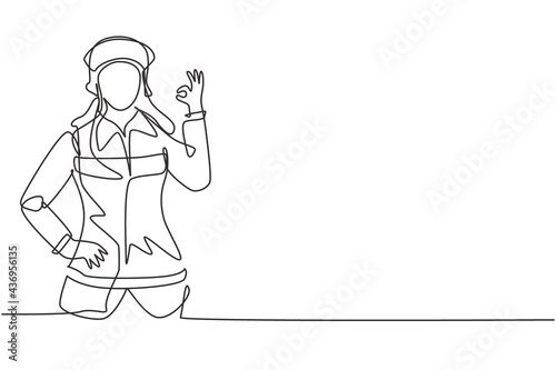 Single one line drawing female firefighter with uniform, gesture okay and hand on waist prepare to put out the fire that burned building. Modern continuous line draw design graphic vector illustration