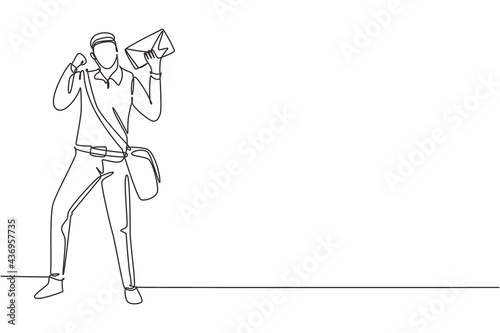 Continuous one line drawing postman standing with celebrate gesture, wearing uniform, bag, and holding envelope delivering mail to home address. Single line draw design vector graphic illustration