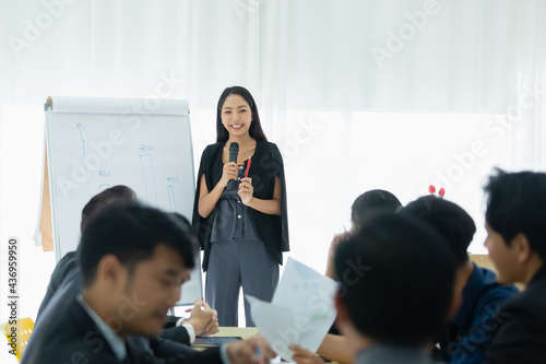 businesswoman talking with whiteboard presentation seminar corporate in meeting room, training business person. © eakgrungenerd