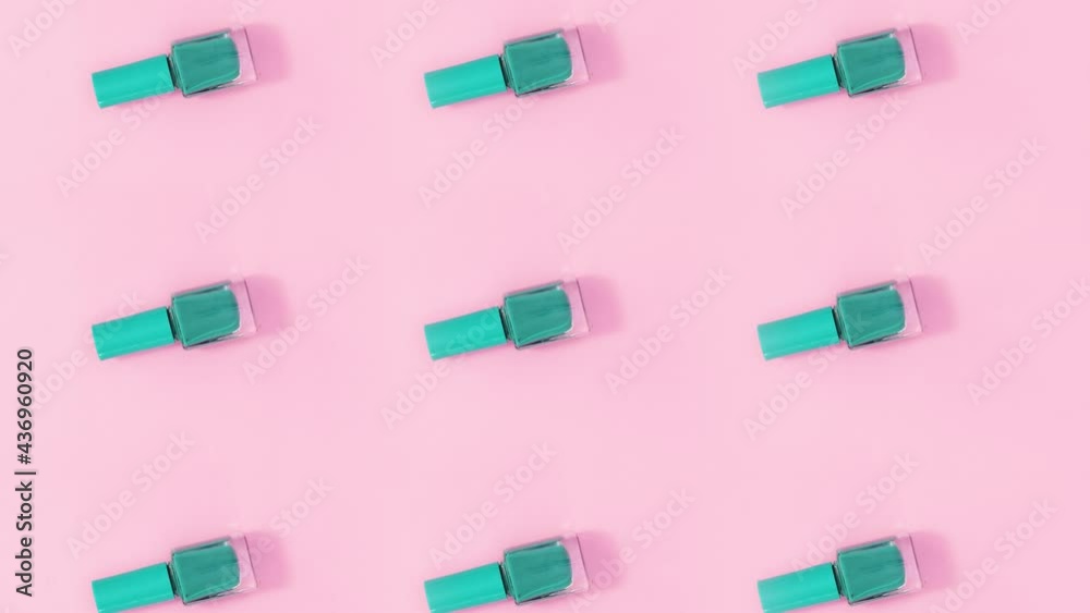 Beauty concept pattern made of nail polishes bottles in same color rotate on bright pink theme. Stop motion Beauty concept pattern made of nail polishes bottles in same color rotate on bright pink theme. Stop motion