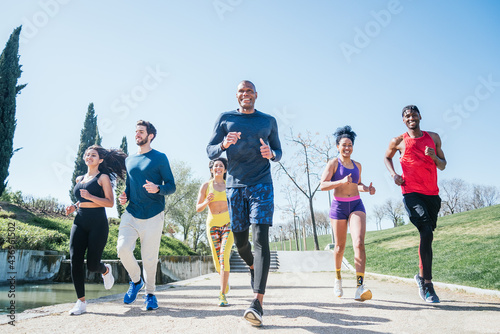 Group of runners training in a park.
