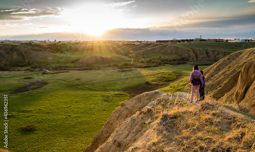 Obraz na płótnie Medicine Hat Alberta Canada, May 14 2021: Two children watch a sunset over Seven Persons Coulee while on vacation in a Canadian City