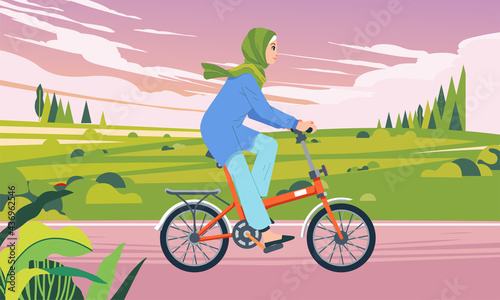 a woman riding a bicycle in a valley area in the afternoon when the sky was cloudy