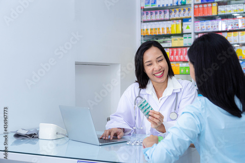 Portrait of female doctor or pharmacist discussing with female patient. Healthcare and medical concept...