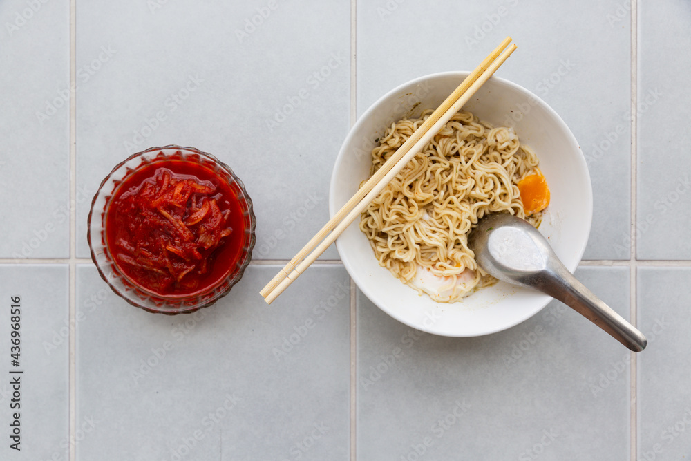 Fototapeta premium spicy instant noodles with egg and kimchi - korean food style