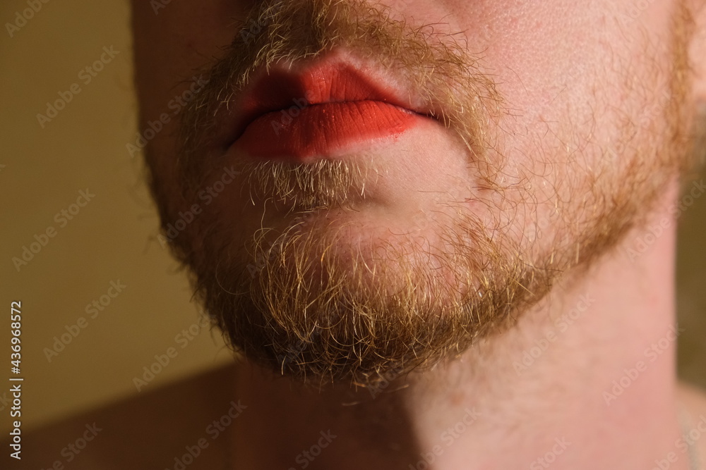 Obraz premium A gender fluid gay man with red lip stick