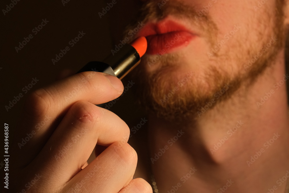 A gender fluid gay man with red lip stick