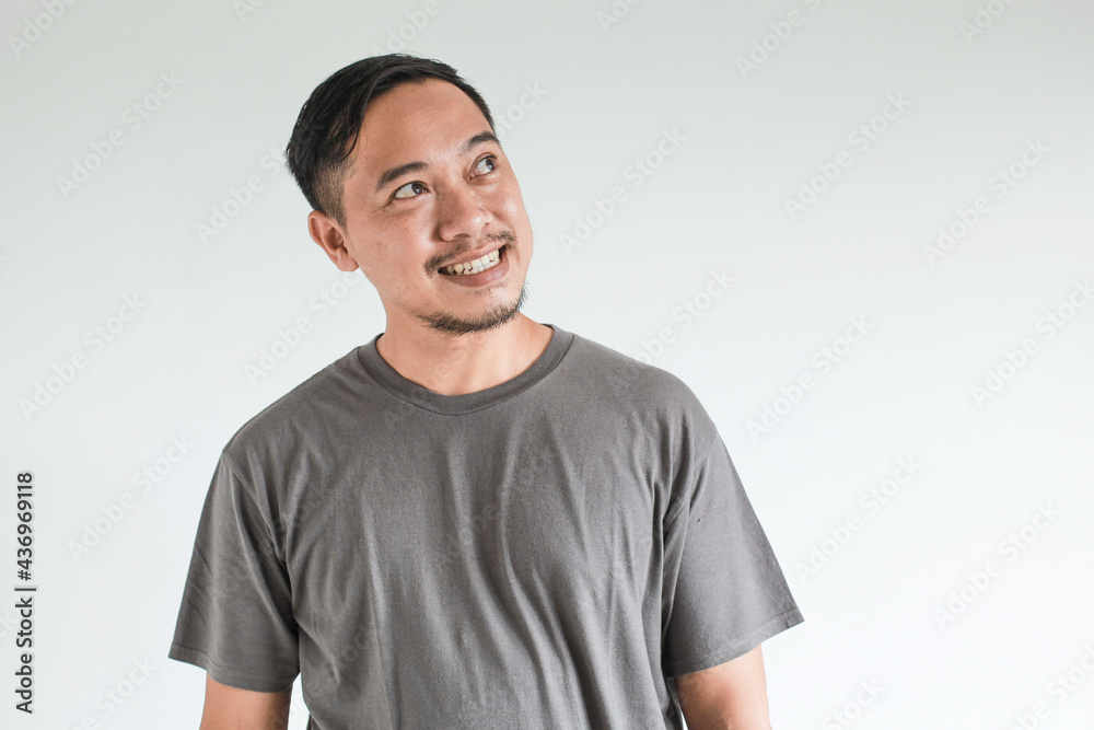 Smile and happy face expression of Asian man point to present an empty space of content. Advertising model concept. Smile and happy face expression of Asian man point to present an empty space of content. Advertising model concept.
