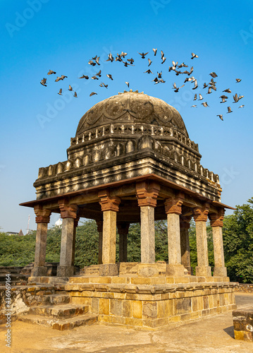 Old Mughal architecture located in Mehrauli archaeological park- New Delhi- India. Pigeons taking off 5 August 2018 