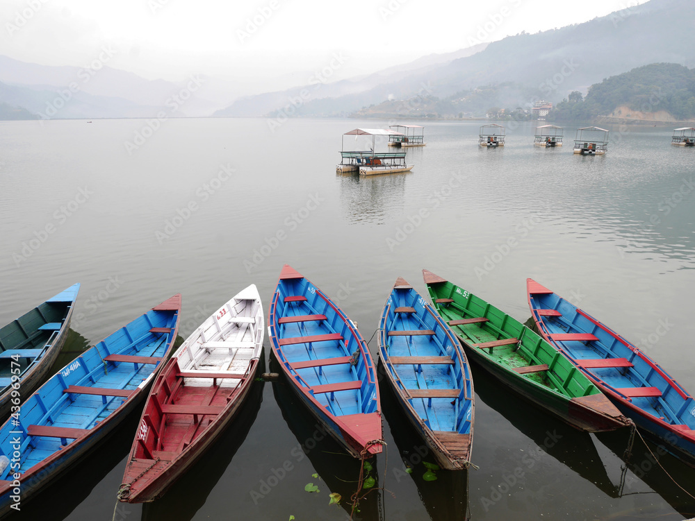Wooden canoe boat of nepali people floating in Phewa Tal or Fewa