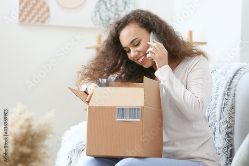 Young woman with parcel tal...