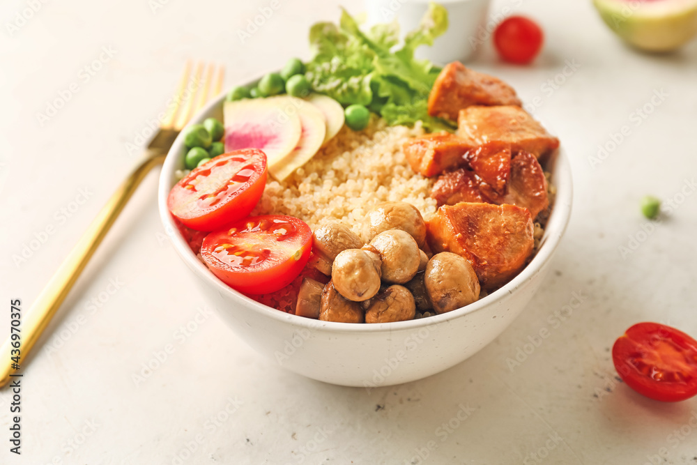 Bowl with tasty quinoa salad on light background, closeup Bowl with tasty quinoa salad on light background, closeup