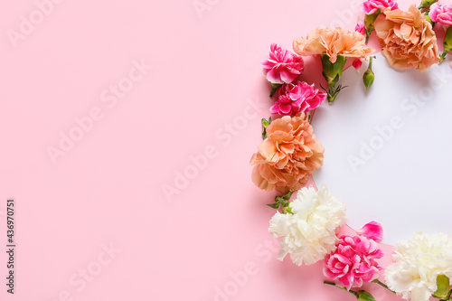 Frame made of beautiful carnation flowers on color background © Pixel-Shot