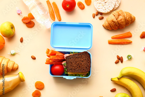Tableau sur toile Lunch box with tasty food on color background