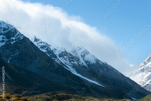 Clouds drifting over snow-capped mountains at Hooker valley, Mt Cook National Park, South Island of New Zealand