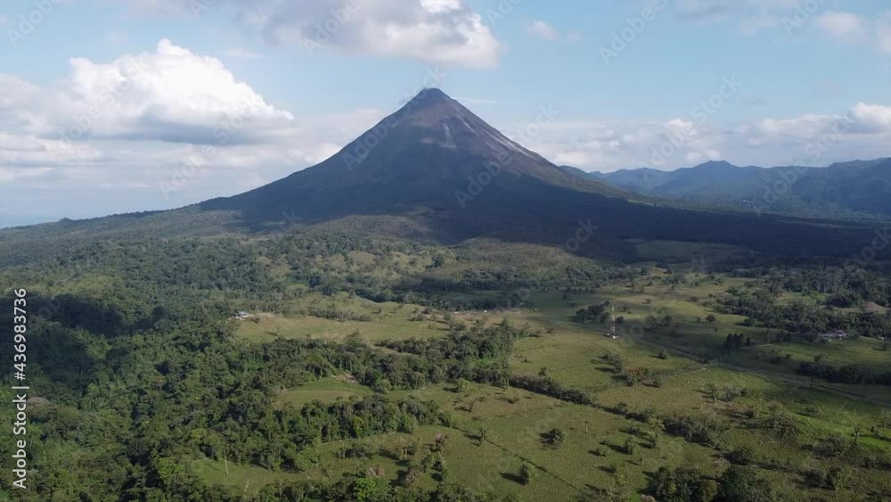 Jungle aerial: Smoke rising from Arenal Volcano cone in Costa Rica Jungle aerial: Smoke rising from Arenal Volcano cone in Costa Rica