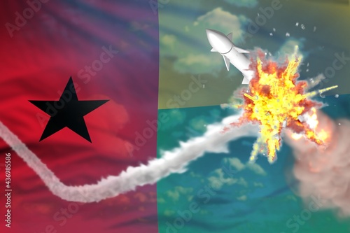 Guinea-Bissau intercepted nuclear missile, modern antirocket destroys enemy missile concept, military industrial 3D illustration with flag photo