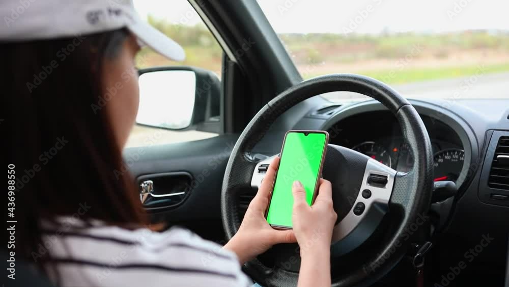 woman sitting in the car using phone woman sitting in the car using phone