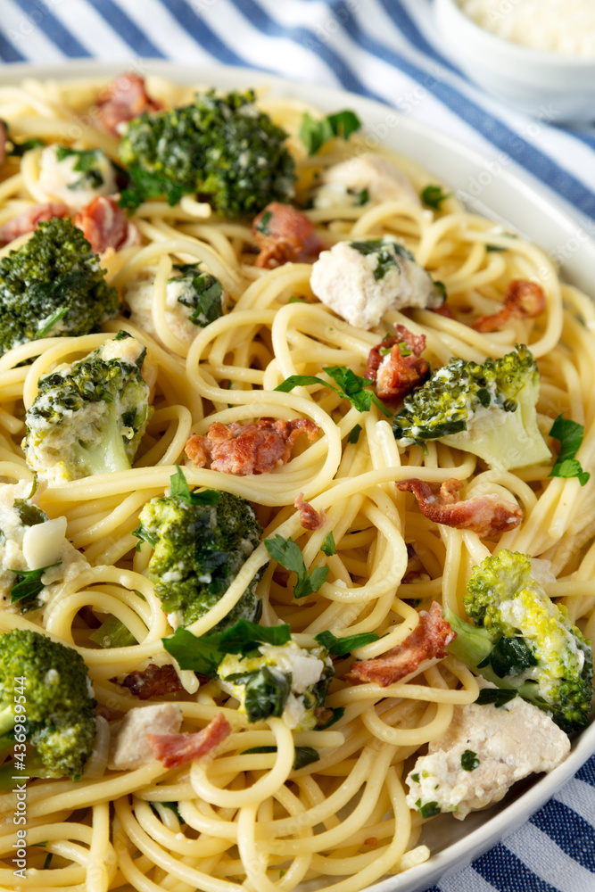 Homemade Chicken Bacon Broccoli Alfredo on a plate, side view. Close-up. Homemade Chicken Bacon Broccoli Alfredo on a plate, side view. Close-up.