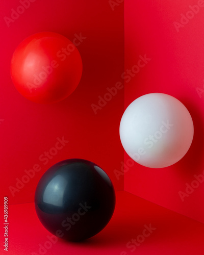 White  red  black balls on a red background. Abstract composition. Design.