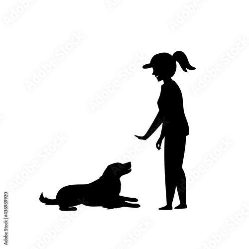 woman training a dog basic commands silhouette