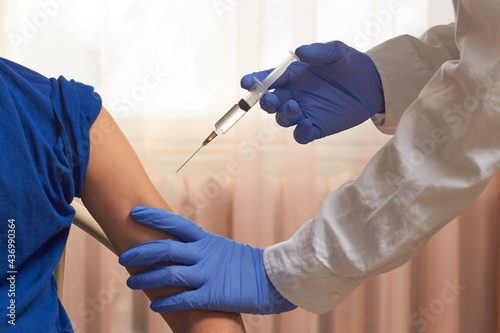 An orderly inoculates a vaccine against viruses. fighting the epidemic vaccination.