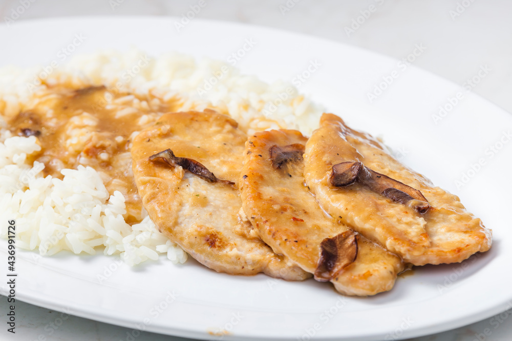 poultry meat with mushroom sauce and rice
