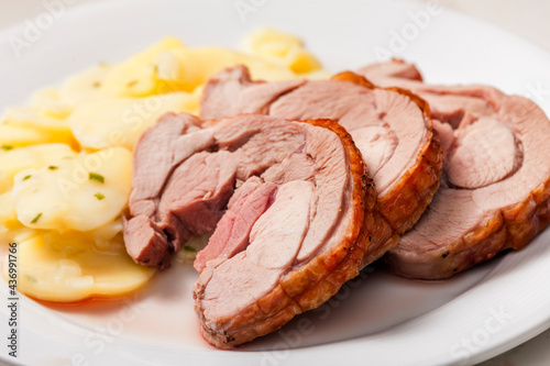 slices of meat served with potatoes