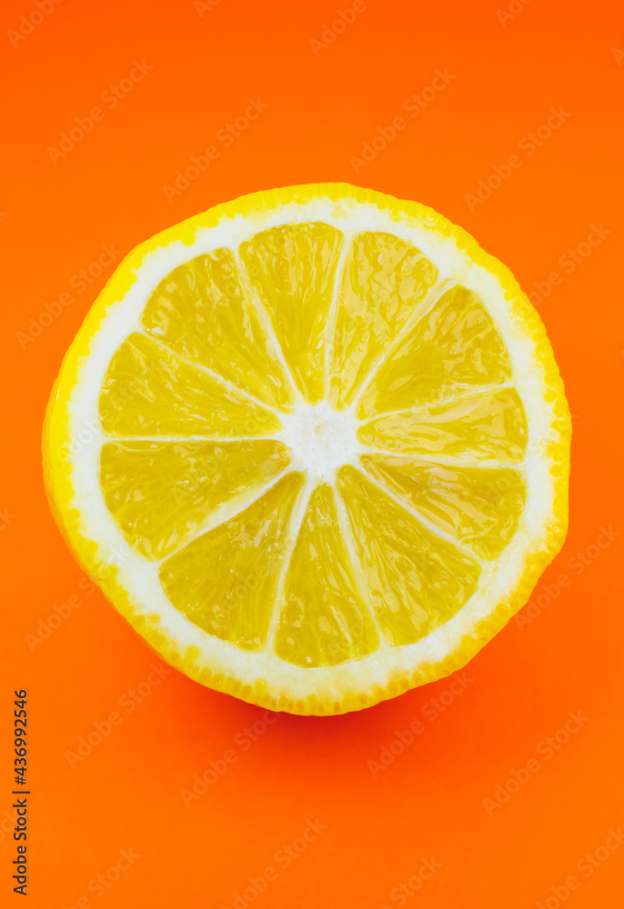 Close up photo of lemon texture on the orange background. Fruit cut in half, inside, macro view. Beautiful natural wallpaper. Close up photo of lemon texture on the orange background. Fruit cut in half, inside, macro view. Beautiful natural wallpaper.