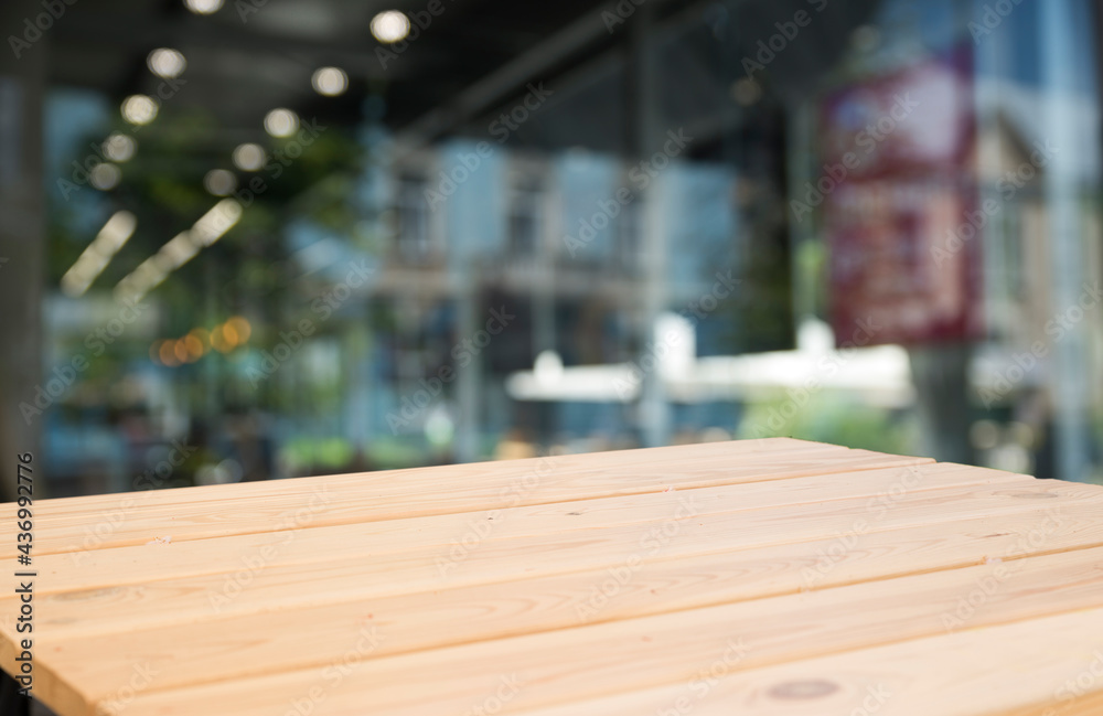 Empty wooden table top with lights bokeh on blur restaurant background. Empty wooden table top with lights bokeh on blur restaurant background.