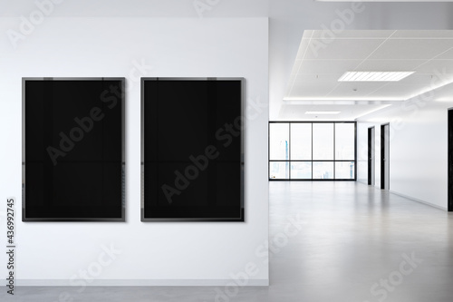 Two vertical frames Mockup hanging on wall. Mock up of billboards in modern concrete office interior 3D rendering © sdecoret