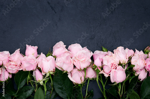 Floral framed composition with pink roses on black background
