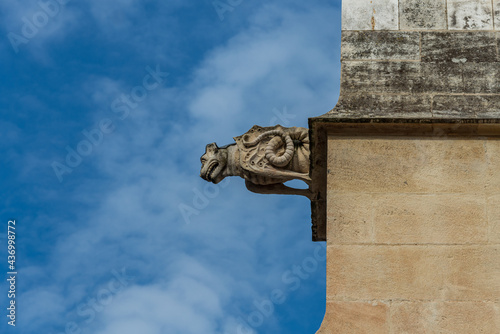  French gargoyle against blue sky on church ,rcent renovation . provence , France  .