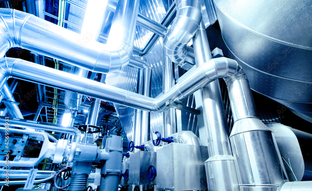 Equipment, cables and piping as found inside of a modern industrial power plant Equipment, cables and piping as found inside of a modern industrial power plant