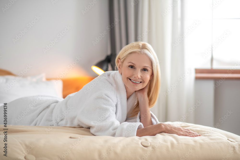 Pretty blonde woman spending time at home and looking contented Pretty blonde woman spending time at home and looking contented