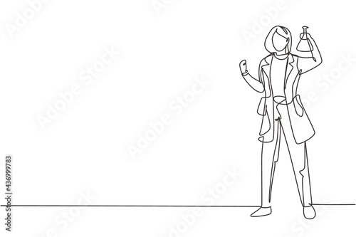 Continuous one line drawing female scientist stands with celebrate gesture and holding measuring tube filled with chemical liquid. Success business. Single line draw design vector graphic illustration