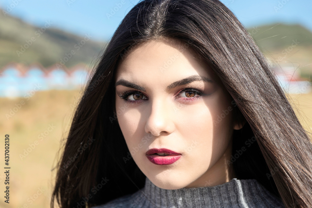portrait of young woman in a wool sweater outdoors portrait of young woman in a wool sweater outdoors