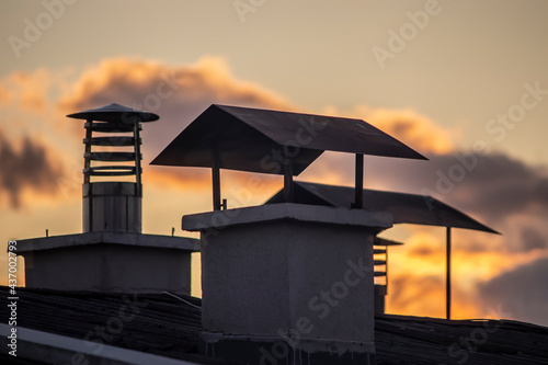various chimneys against the sky. red sky. © Hatice