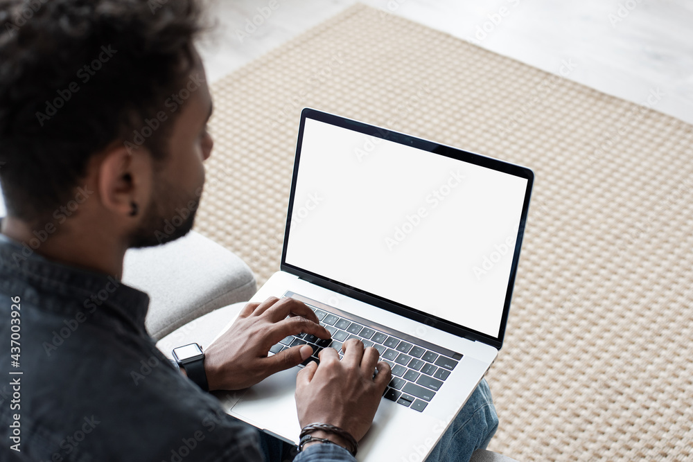 Young man working at home, Mixed race student using laptop computer with empty white blank screen mock-up, meeting online, web conference, studying, e-learning, technology concept Young man working at home, Mixed race student using laptop computer with empty white blank screen mock-up, meeting online, web conference, studying, e-learning, technology concept