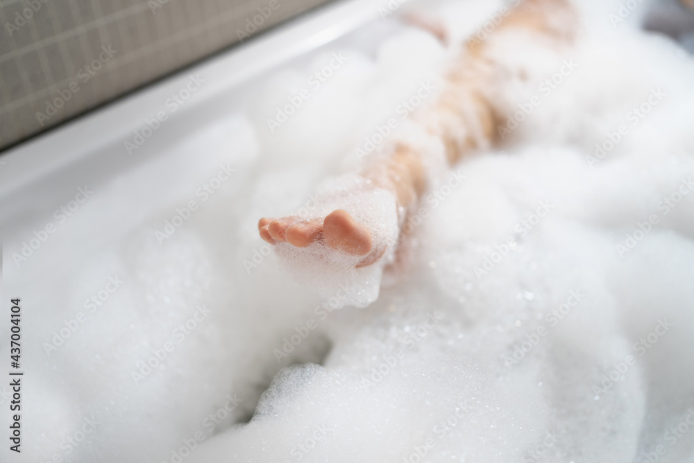 Fototapeta premium Woman's feet bathe in the bathtub