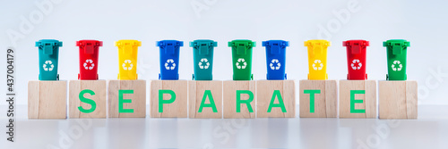 Fotografie Recycling word letters on containers for metal, glass, paper, organics, plastic for further processing of garbage