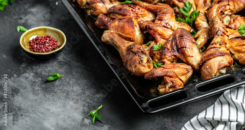 Baked chicken wings and legs on baking tray, banner, menu recipe place for text, top view
