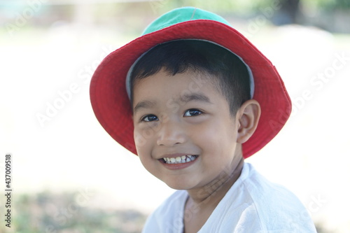 Cute Asian child little Thai boy 2 year old smile make a happy face concept. 