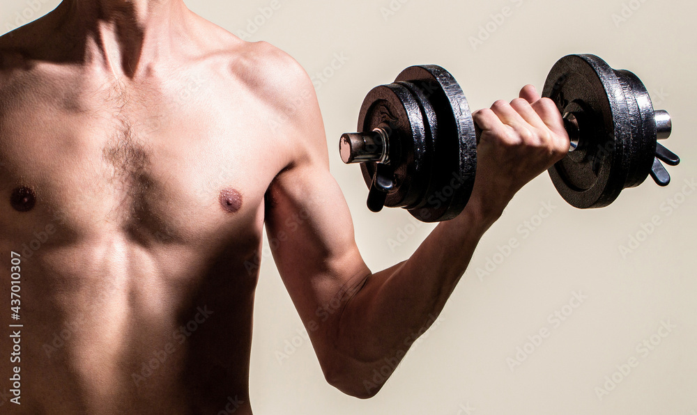 Man holding dumbbell in hand. Skinny guy hold dumbbells up in hands. A thin man in sports with dumbbells. Weak man lift a weight, dumbbells, biceps, muscle, fitness. Nerd maleraising a dumbbell