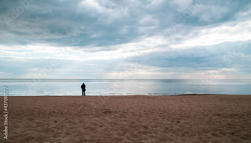 The man stands by the sea  looks into the distance and thinks about his life.