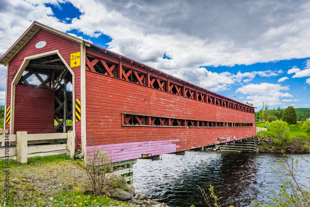 View on the Heppell covered bridge, spanning over the Matapedia river near Causapscal in Quebec (Canada)